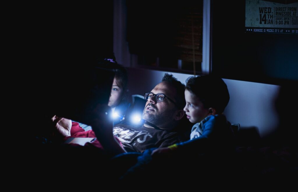 man in blue shirt lying on bed from Reading Order for Kids: Parent’s Spoiler-Safe Guide